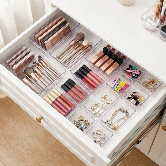 Clear drawer organizer trays holding makeup and accessories